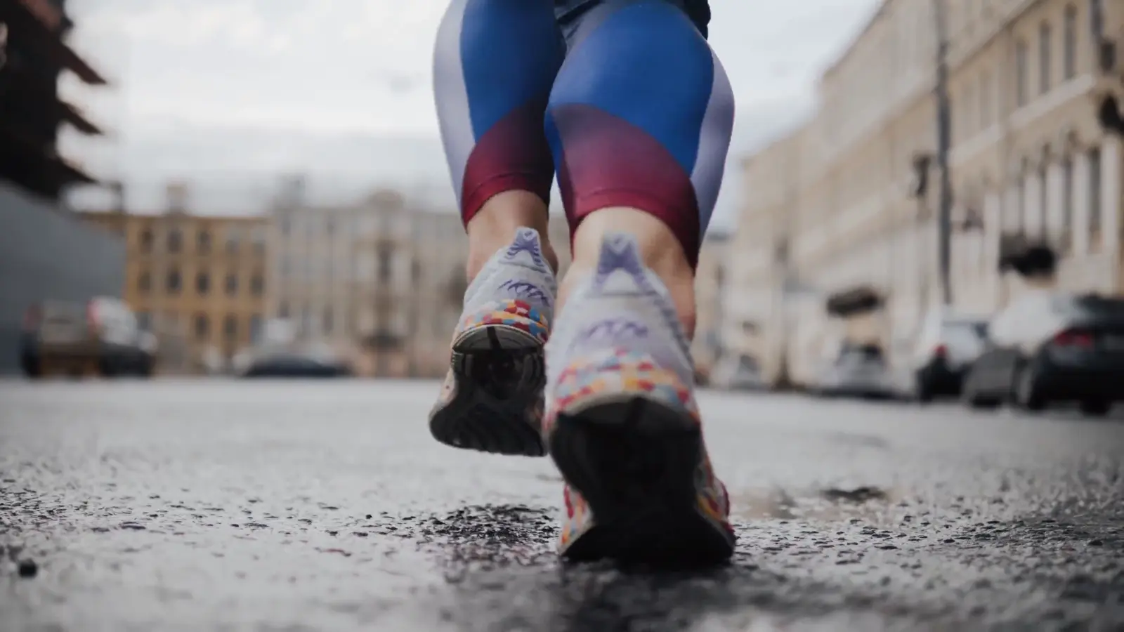 Runner wearing colourful sneakers on a city street
